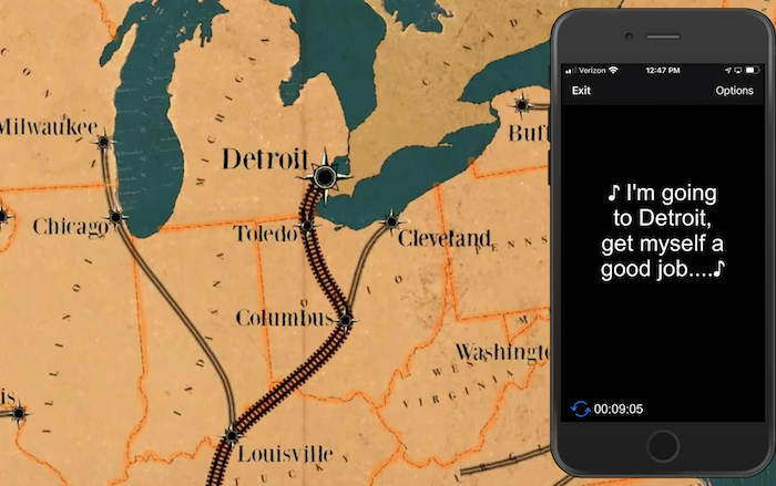 Map in sepia. Detroit is marked with a large star. On the right, over the image, a phone displays the following captions in large print: ♪ I'm going to Detroit, get myself a good job...♪