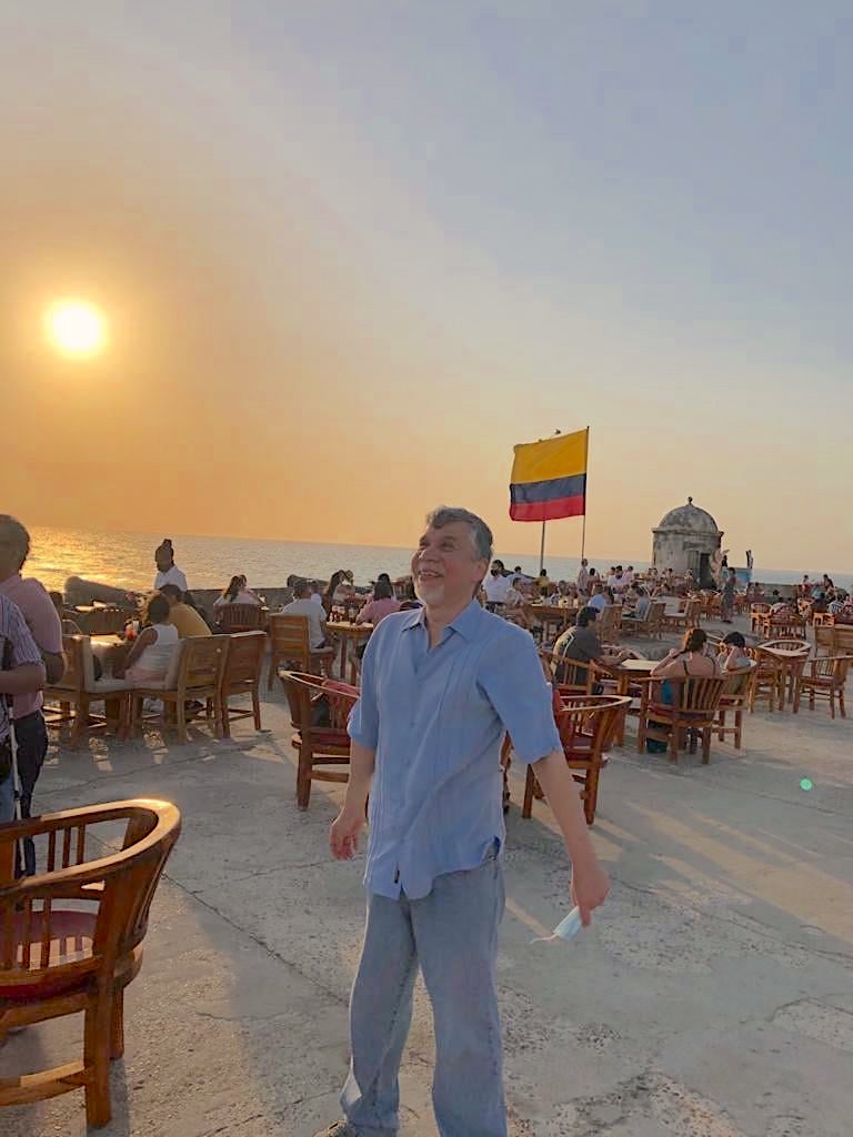 Dean posing in front of a colombian flag