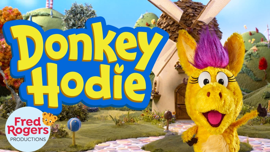 A puppet of a yellow horse with pink hair