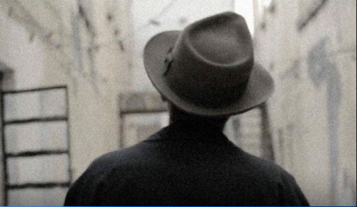 a man with a 40's suit seen from the back