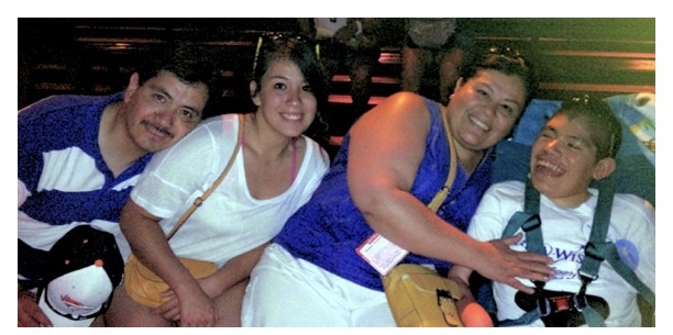 Myrna,her husband, daughter and son in a theme park