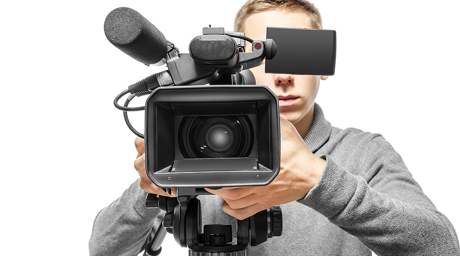 A man holds a professional camera.